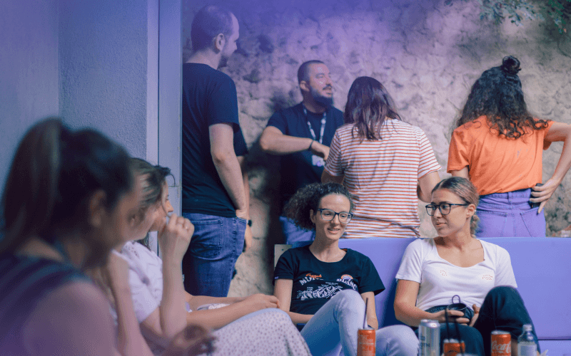 A group of people in a room, enjoying each other's company