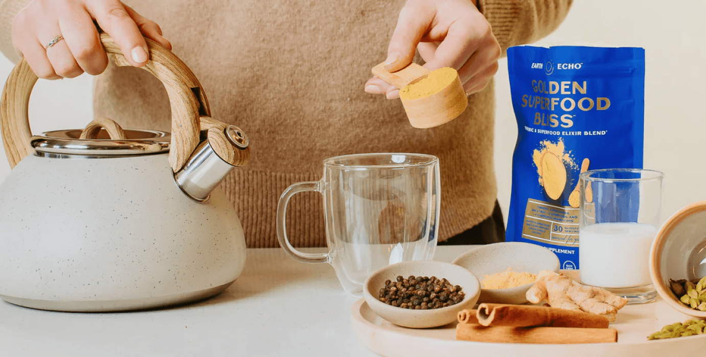 A woman pouring a tea kettle with spices and ingredients and the Earth Eco product packaging.