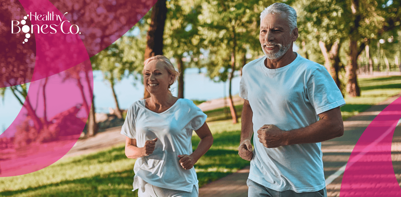 An older couple jogging together in a sunny park.